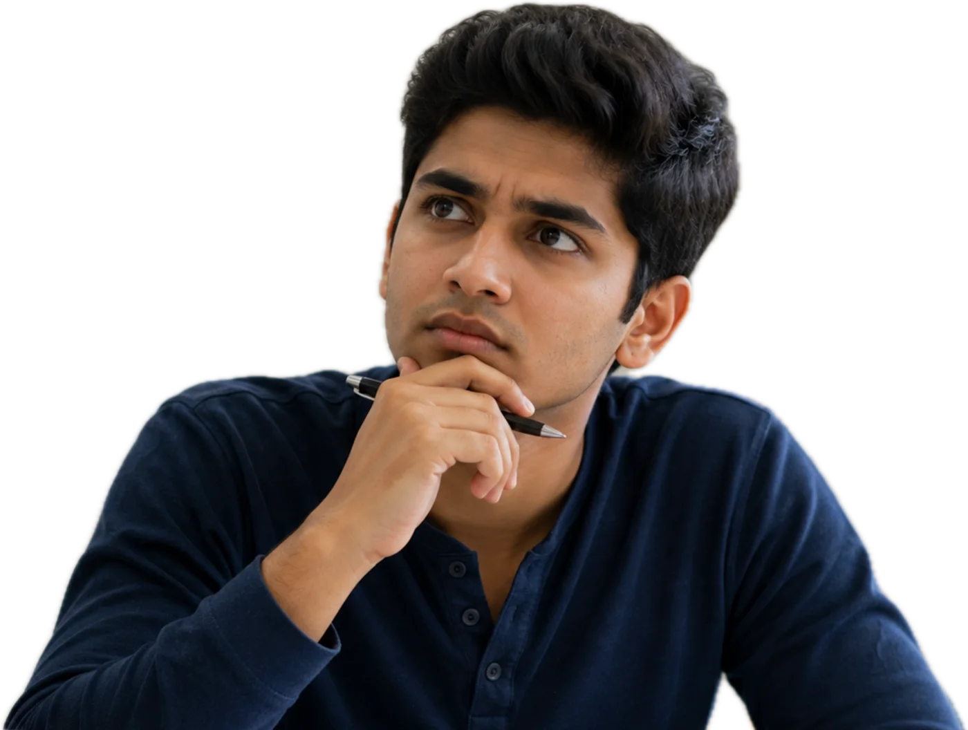 A student in a navy shirt thinking, chin on his hand, a pen between his fingers.